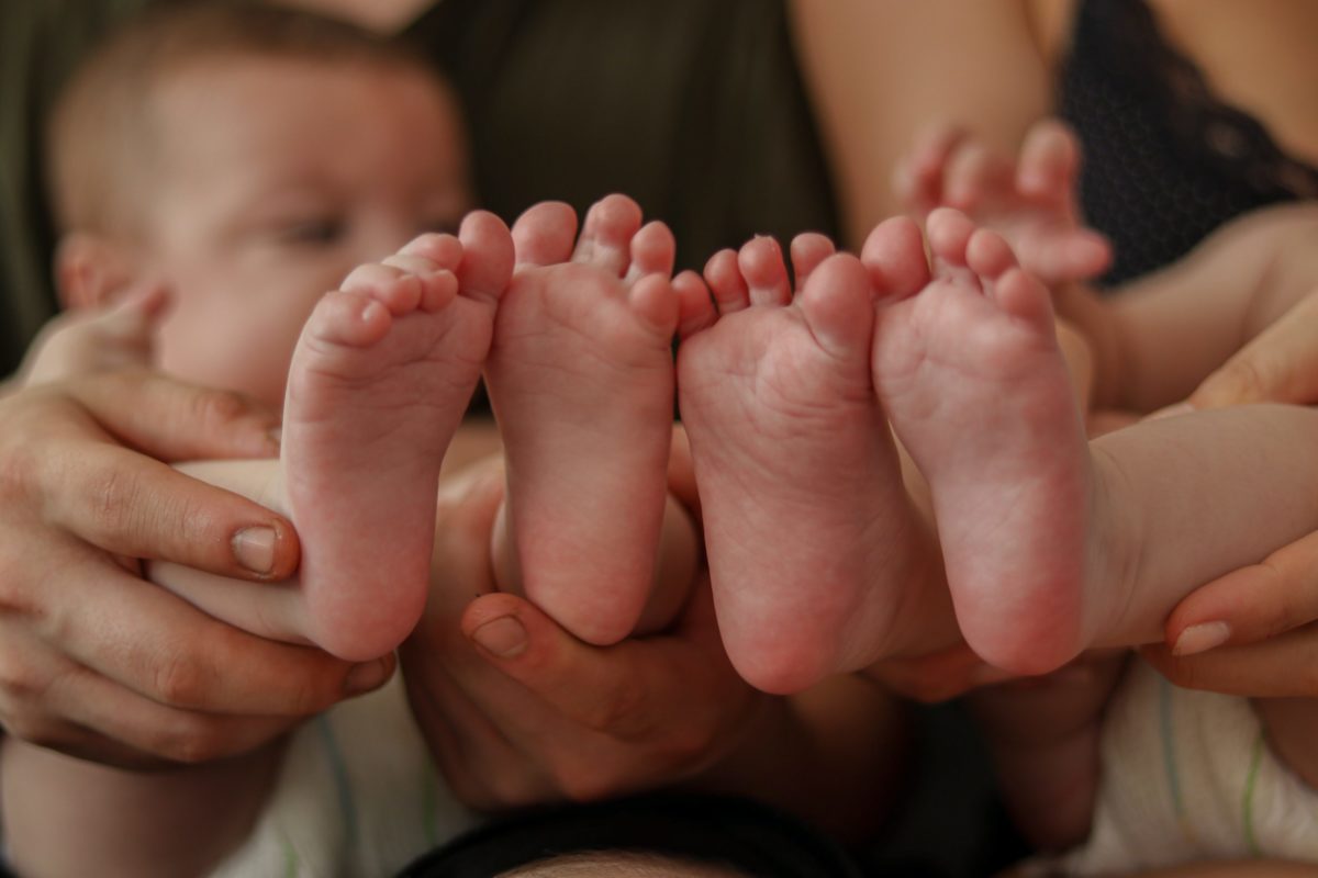 two pair of baby feet