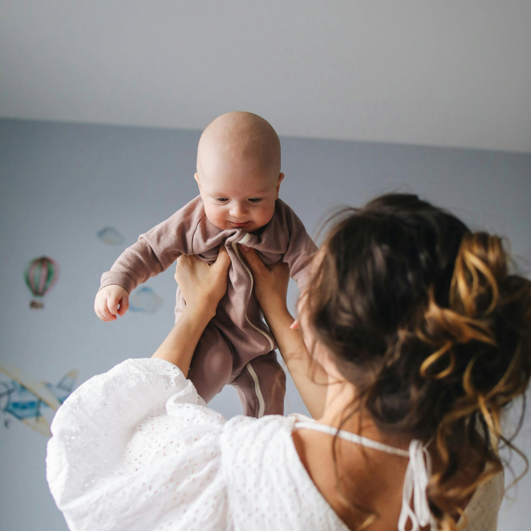 Mom holding baby in the air