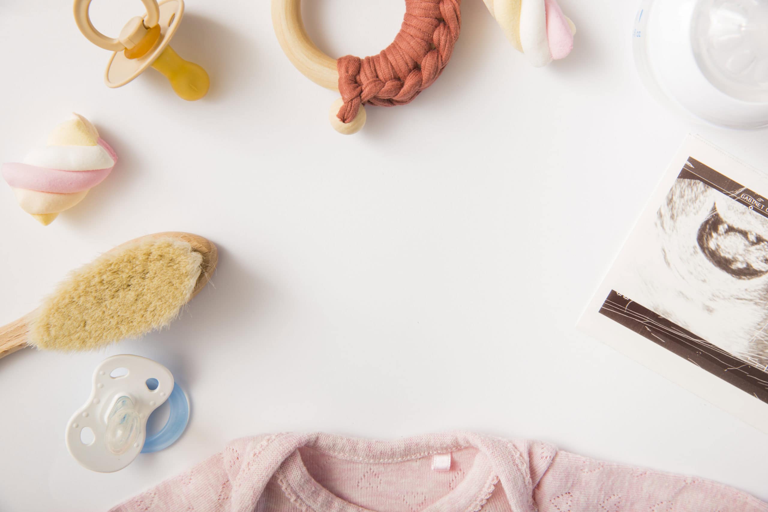 Baby essentials, including toys, a onesie, brush, pacifier, and more!