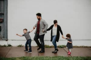 parents walking with their children on the sidewalk